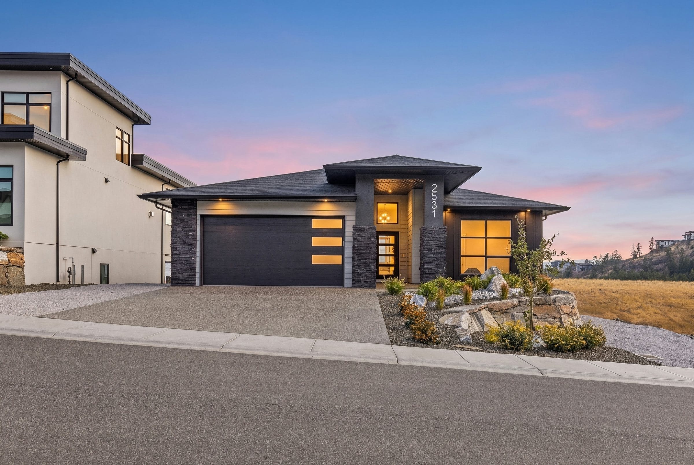 2531 Pinnacle Ridge Drive at dusk, the front of the home with the lights on