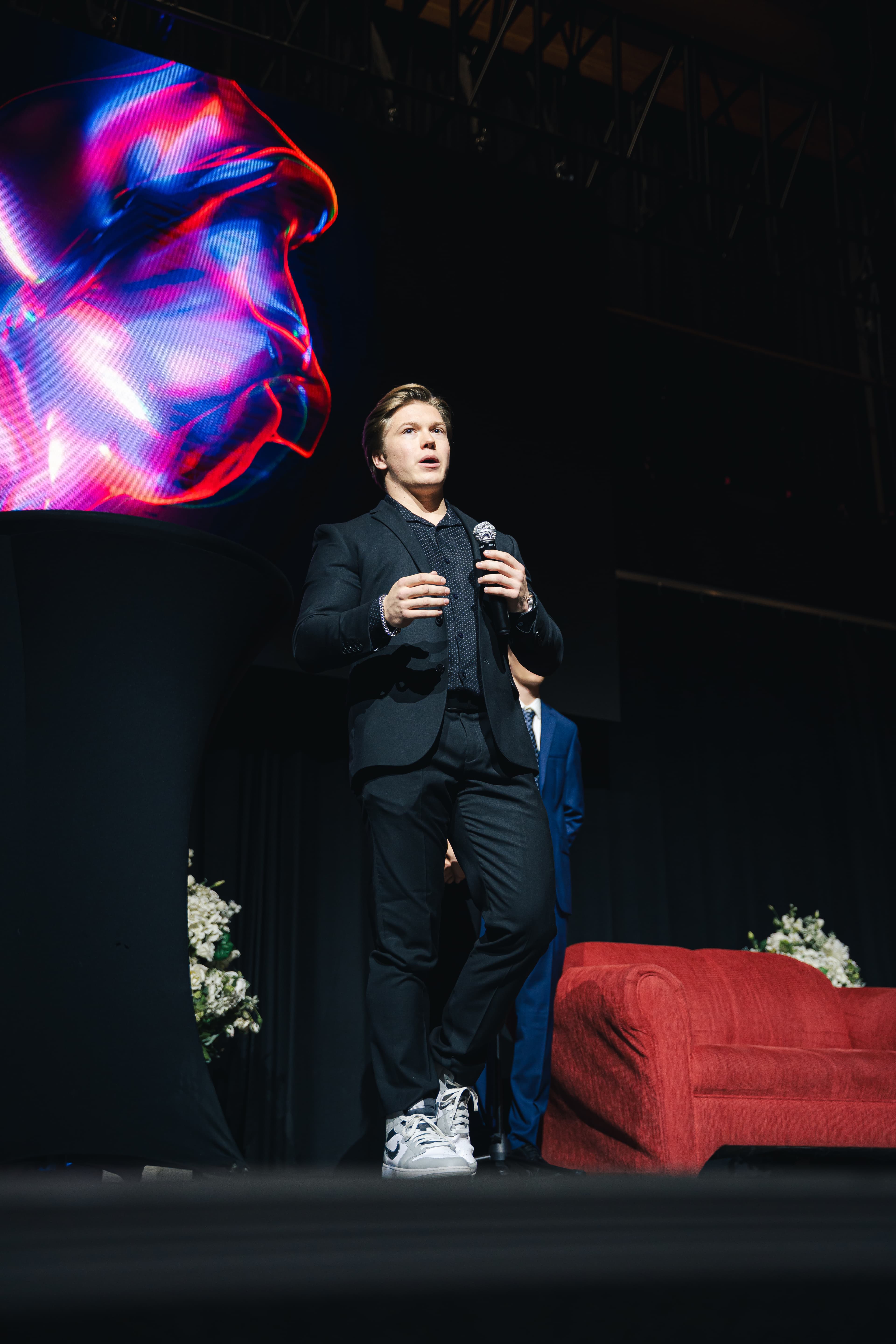 Karsen speaking on stage