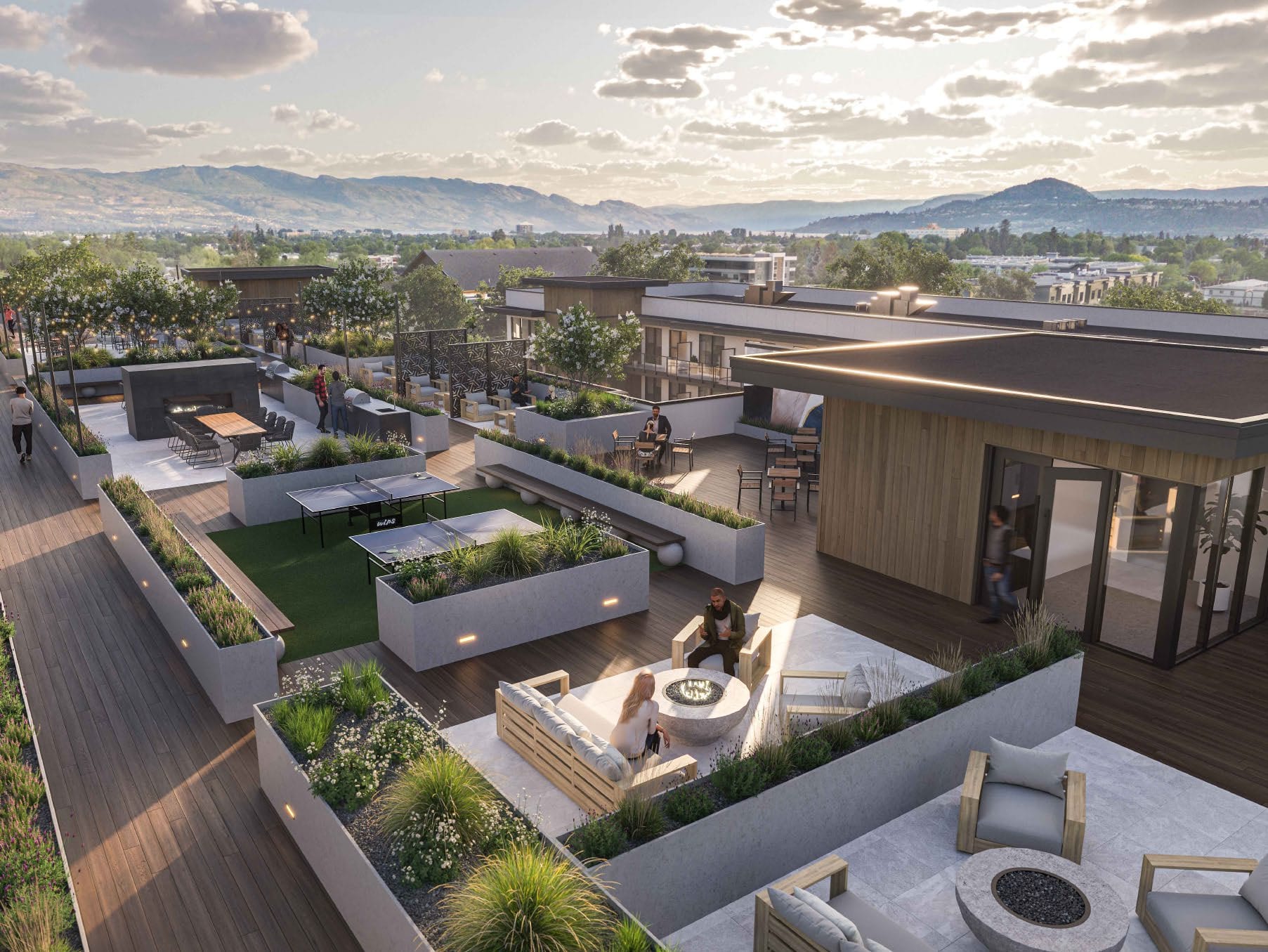 Rendering of the Revo Kelowna rooftop terrace at dusk, with fire tables, ping pong and mountain views