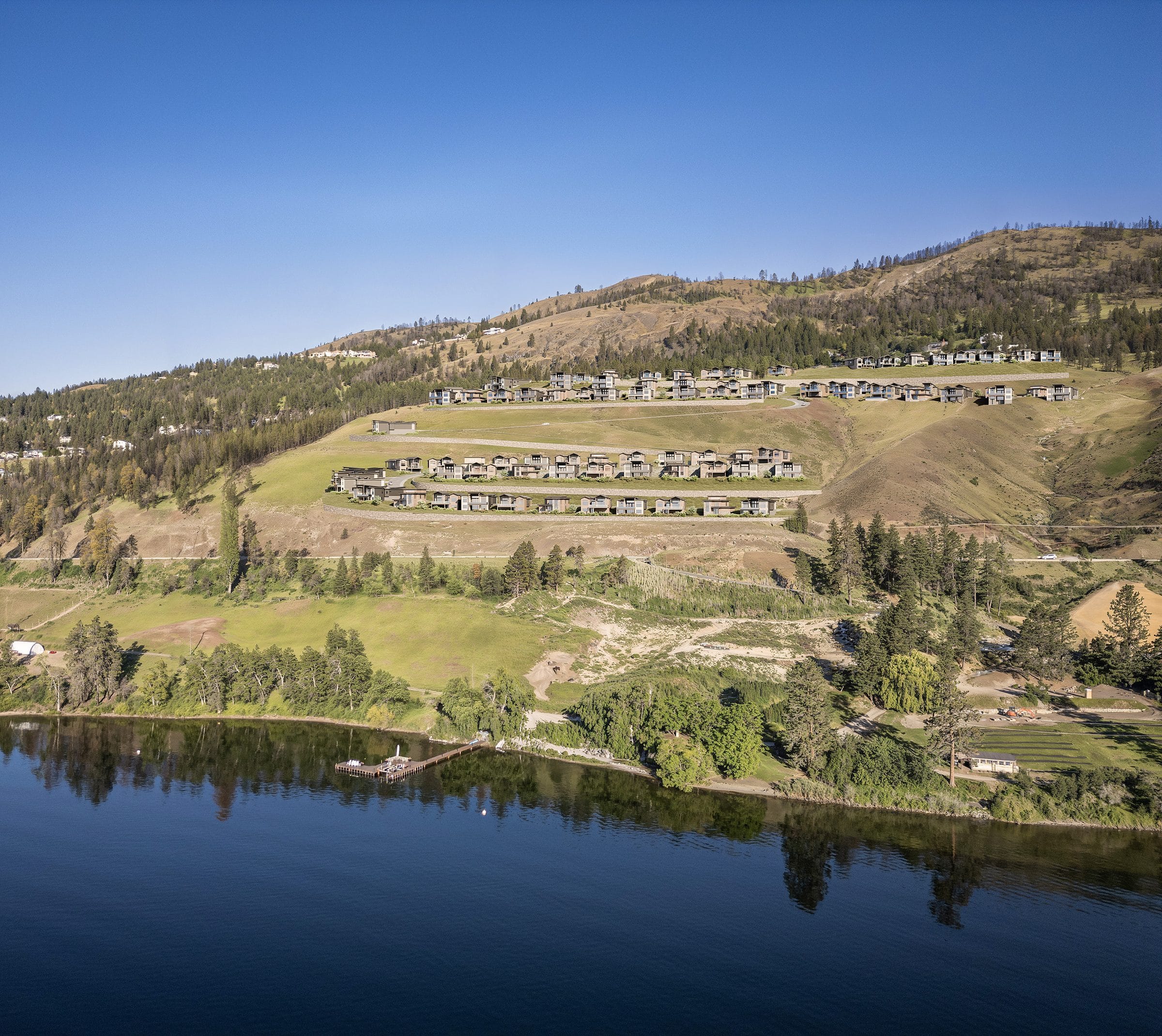 Rendering of Rosevale Estates seen from Okanagan Lake, homes terraced up the hillside above the lakeshore park