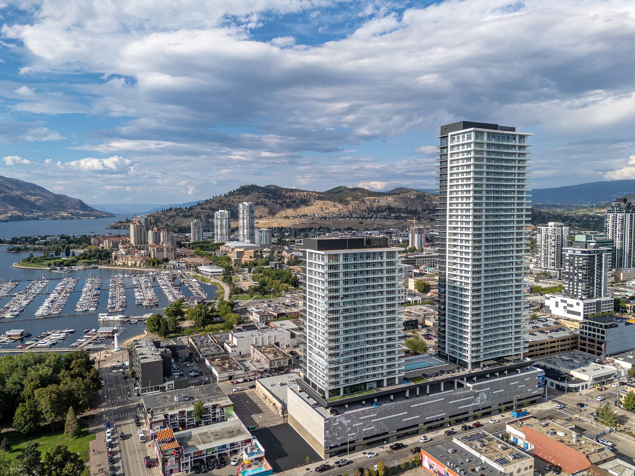 The two towers over the downtown marina, with Okanagan Lake and the mountains beyond