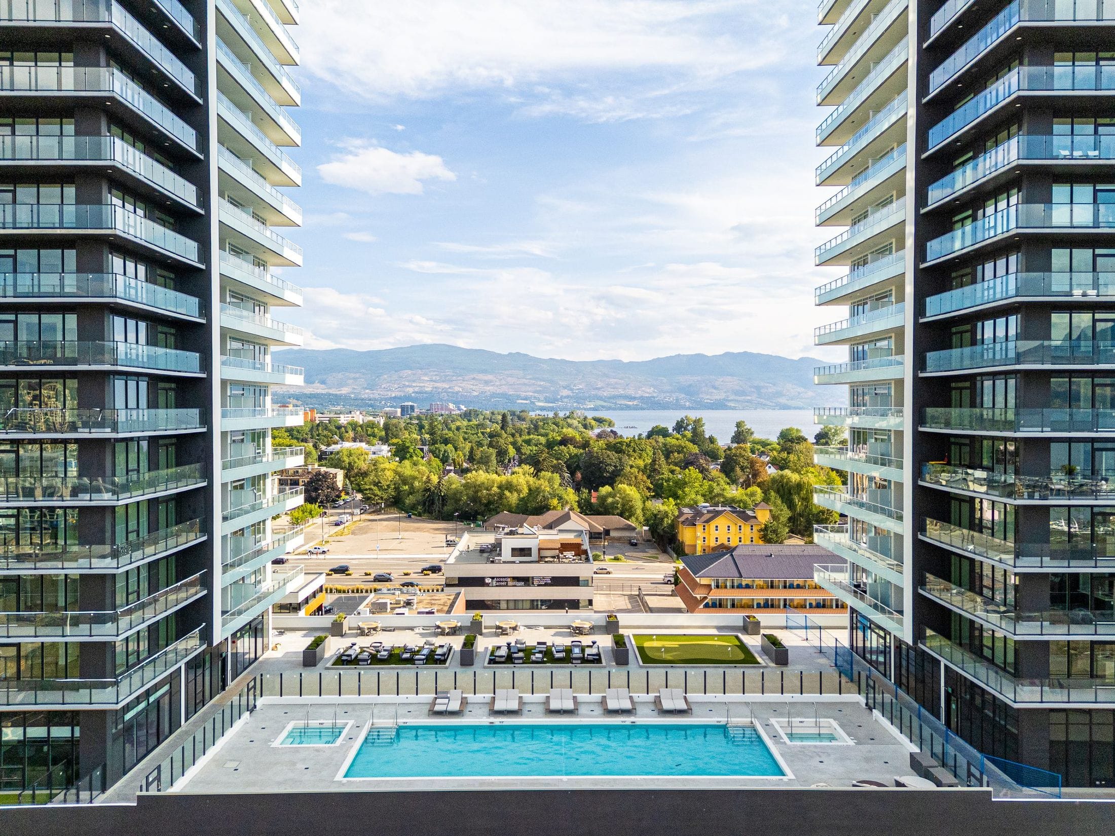 From between the two towers, The Deck runs from the pool past the terrace and putting green to City Park, Okanagan Lake and the mountains