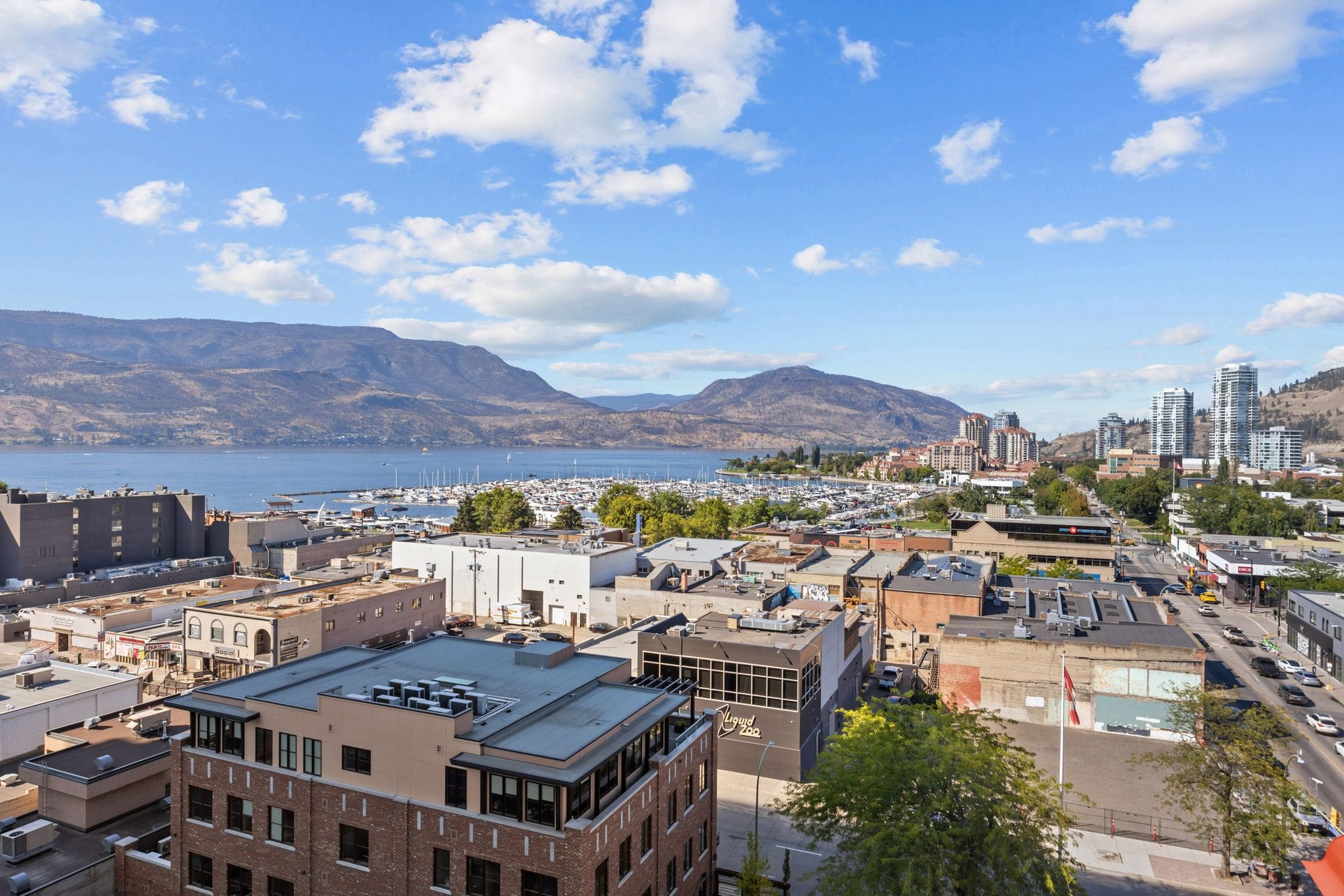 Downtown Kelowna opens to the marina, the lake and the hills from the amenity level