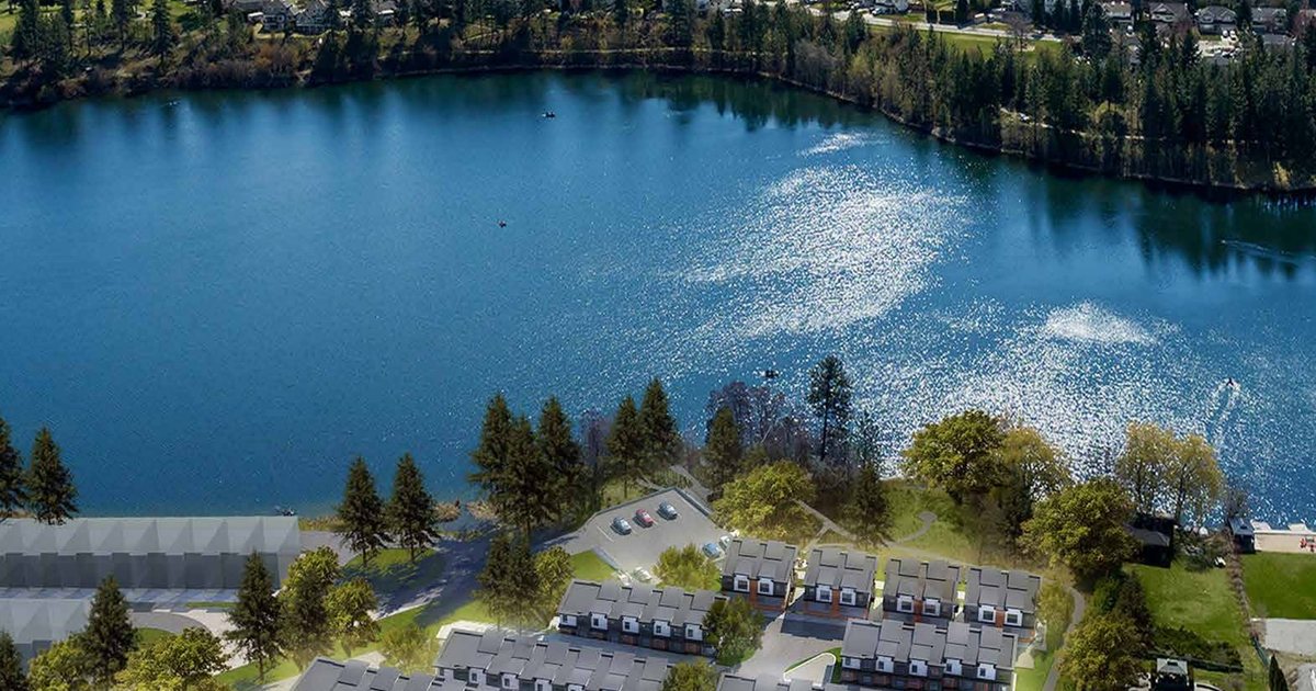 Rendering of the Shannon Lake townhomes at Shannon Lynn on the Lake in West Kelowna from the air, the homes on the shore with Shannon Lake behind them